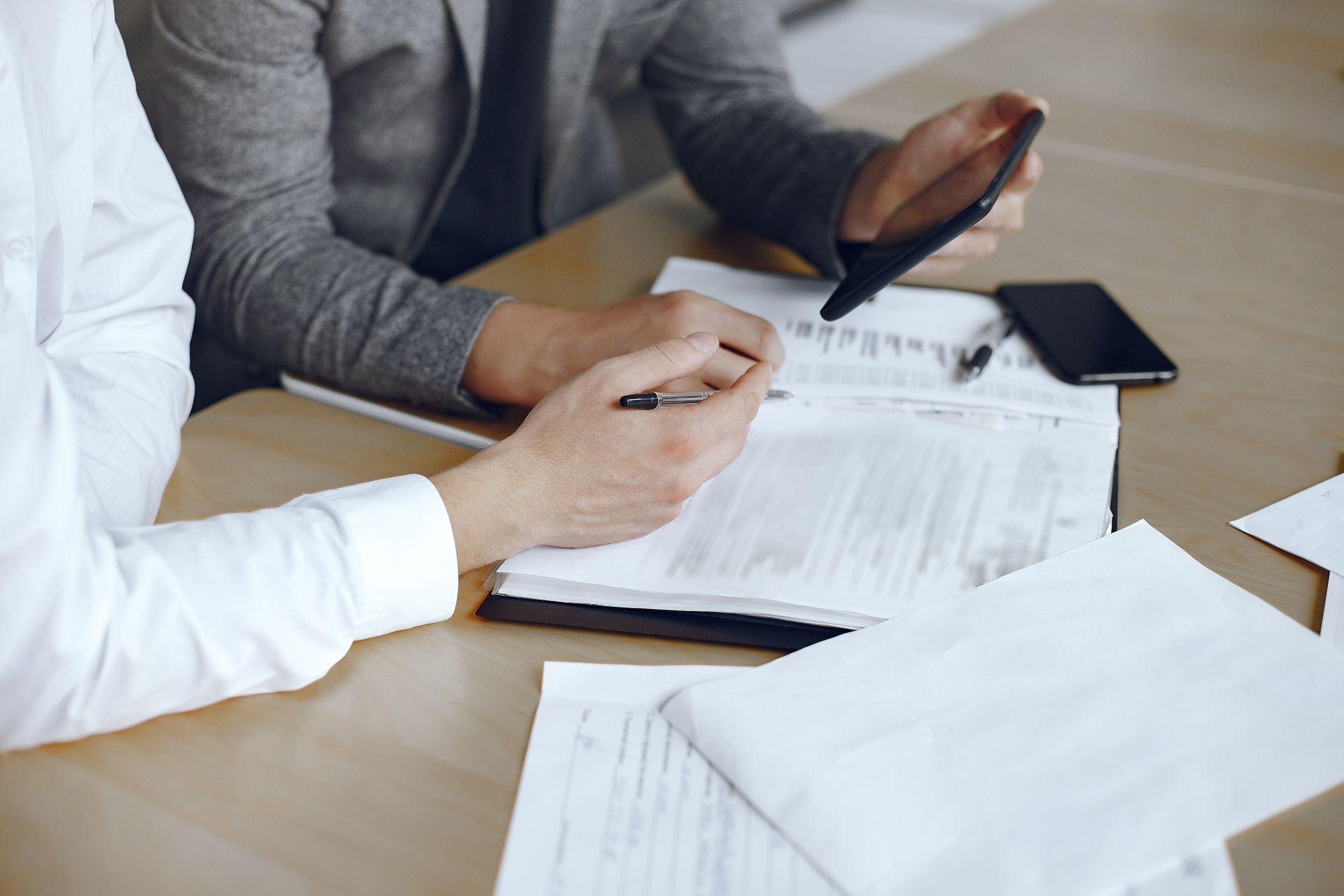 Business associates signing paperwork to set up a supplement company legally.